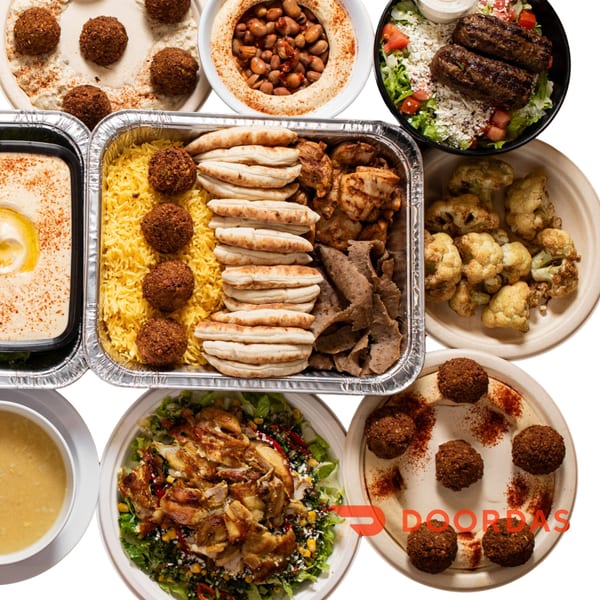 Joe's Falafel spread with falafel, hummus, rice, pita, chicken, gyro, salad, and soup.